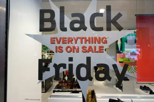Shops on Oxford Street, London, advertise their Black Friday promotions and sales.