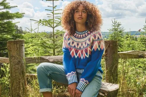 White Stuff AW24 campaign image - woman in knitwear and jeans