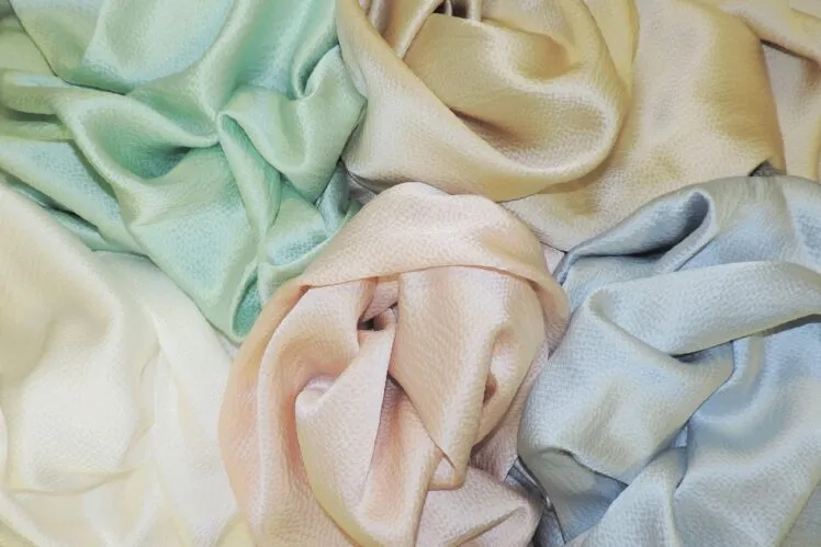 A bundle of Bennett Silks in pearly satin shades of pastel yellow, green, blue and pink shades