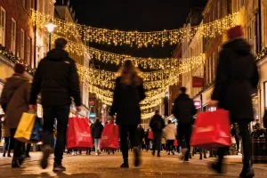 Christmas high street with shoppers carrying shopping bags