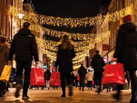 Christmas high street with shoppers carrying shopping bags
